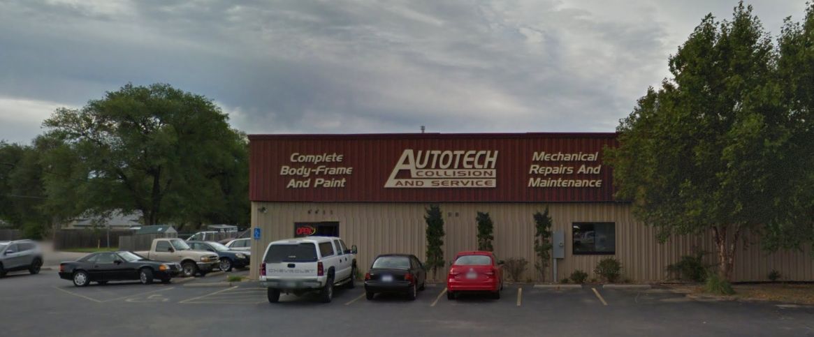 Auto body shop storefront with parked cars under cloudy sky. | Autotech Service