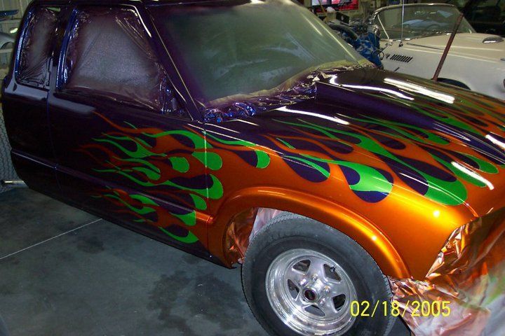 Customized orange and purple hot rod with flame graphics parked indoors | Autotech Service
