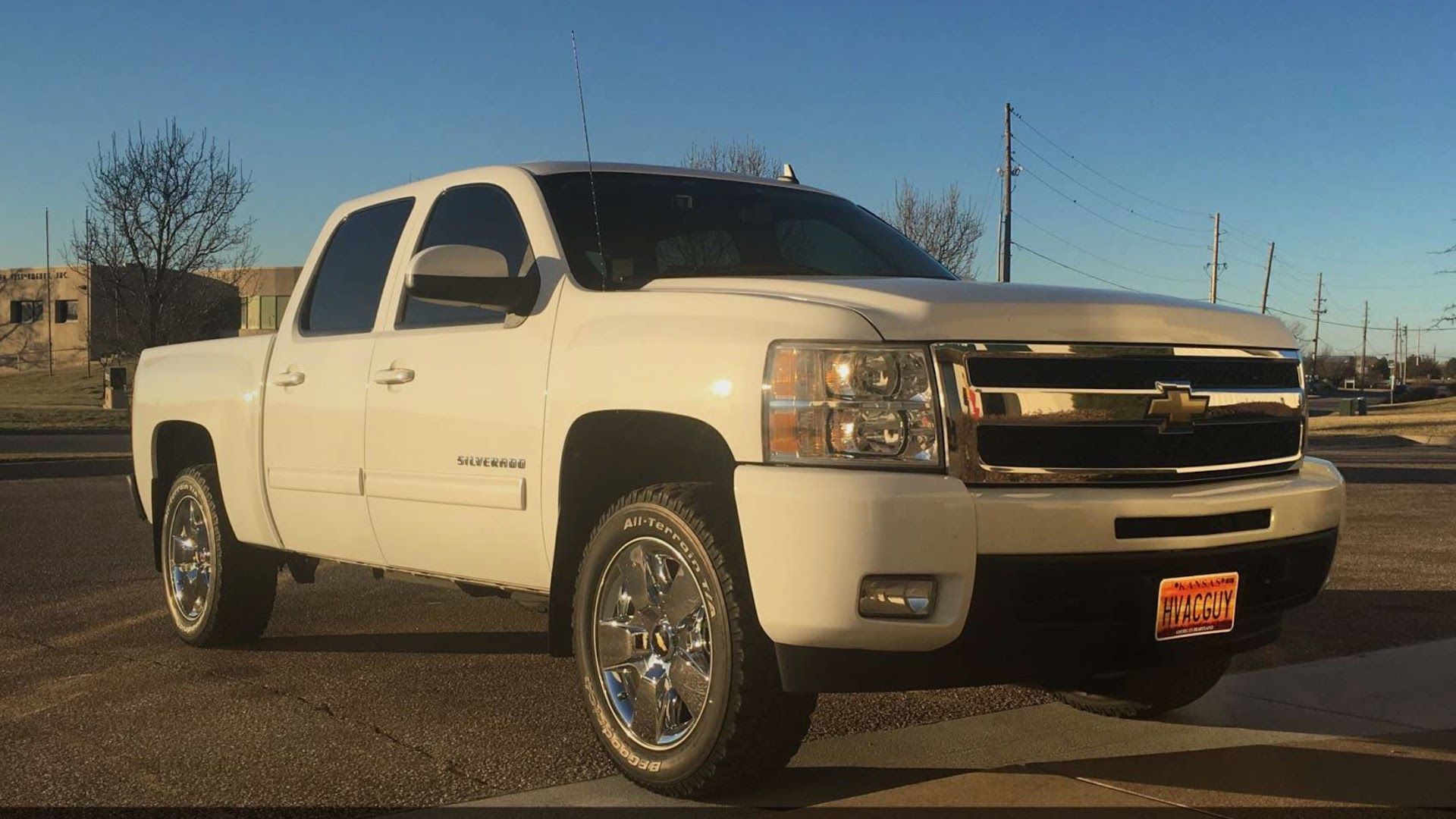 White pickup truck parked outdoors on a sunny lot, viewed from the front-left side. | Autotech Service