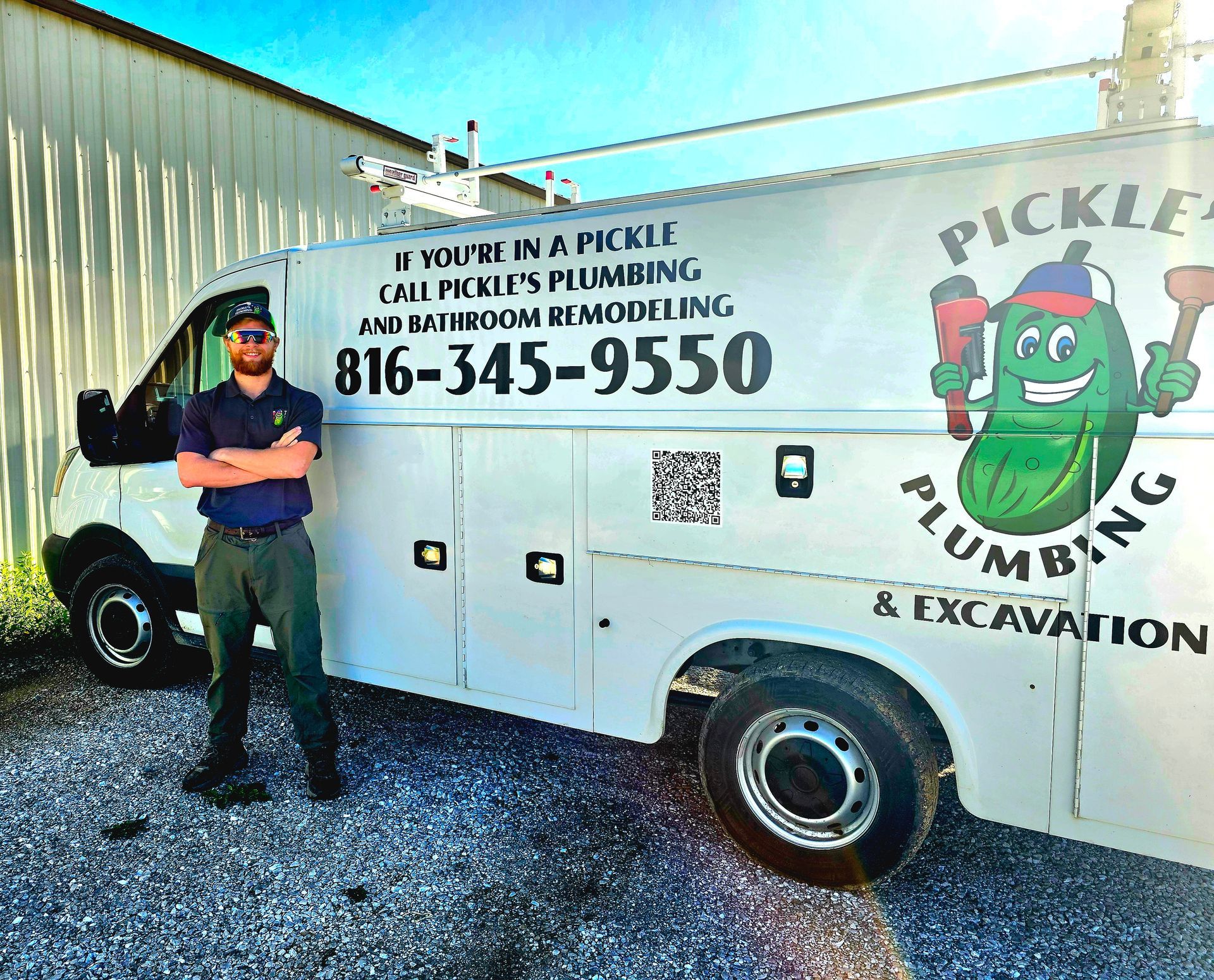 Man standing beside a white Pickle Plumbing & Excavation van with phone number and logo.