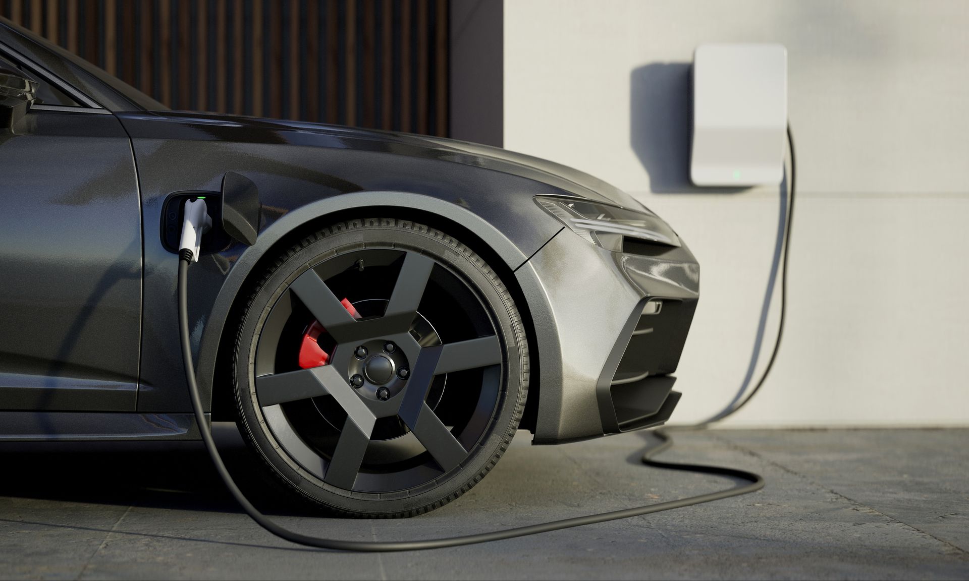 Dark gray electric car charging at a home charging station.