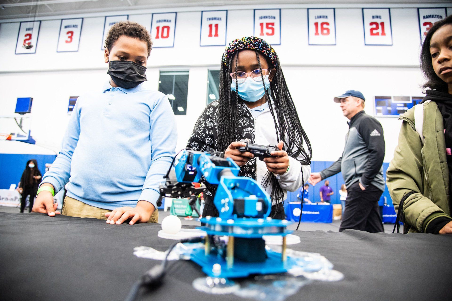CODE313 scholars building and programming a robot