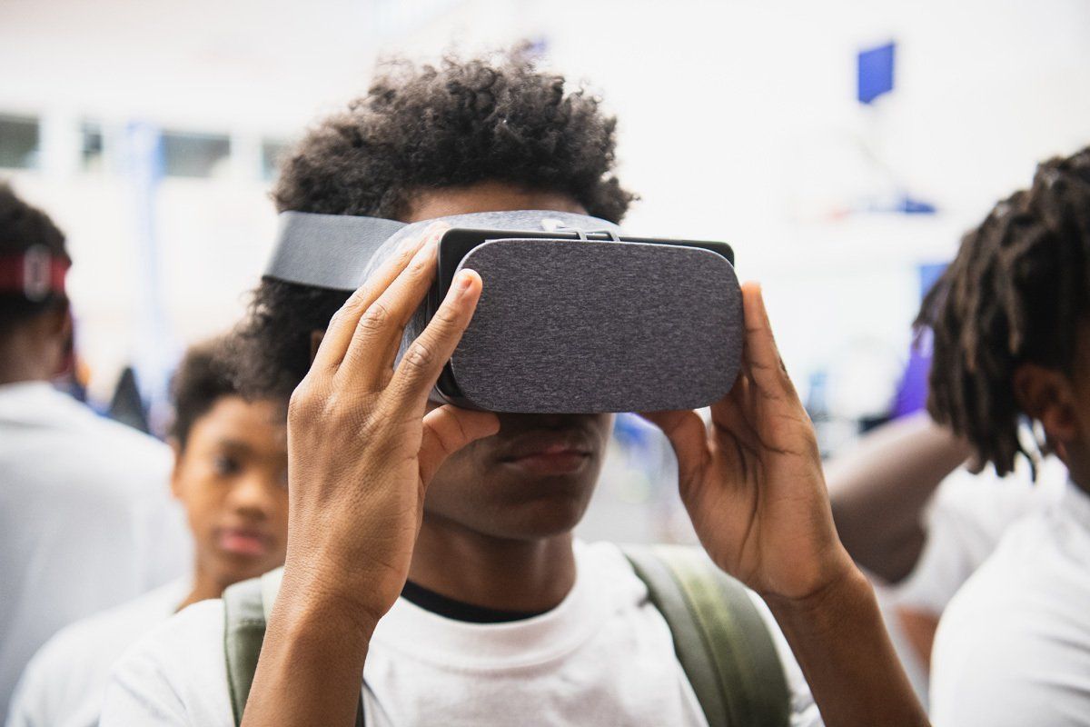A CODE313 scholar exploring a virtual reality headset
