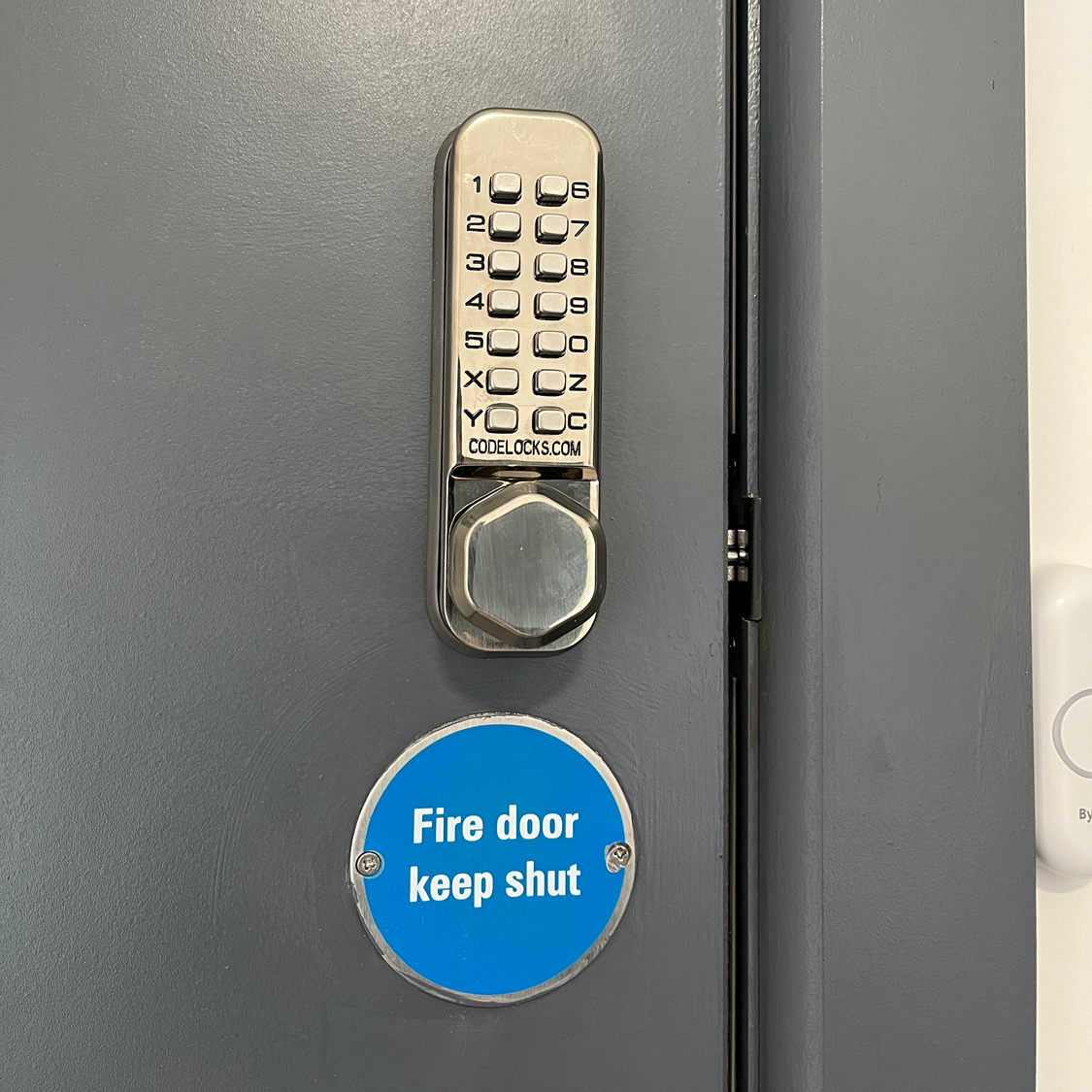 Gray metal door with keypad lock and