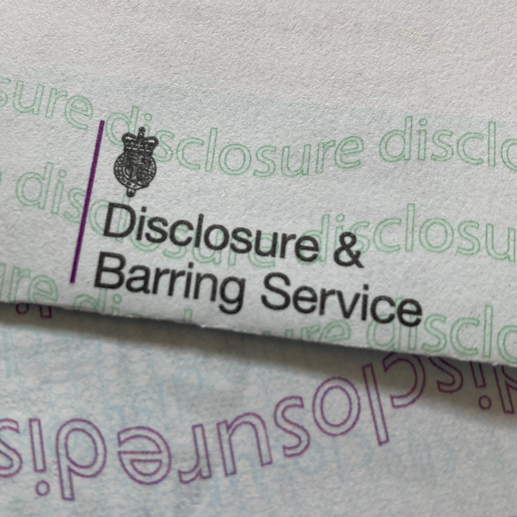 Disclosure & Barring Service logo, text in black and purple, on a white background. Includes a crown.