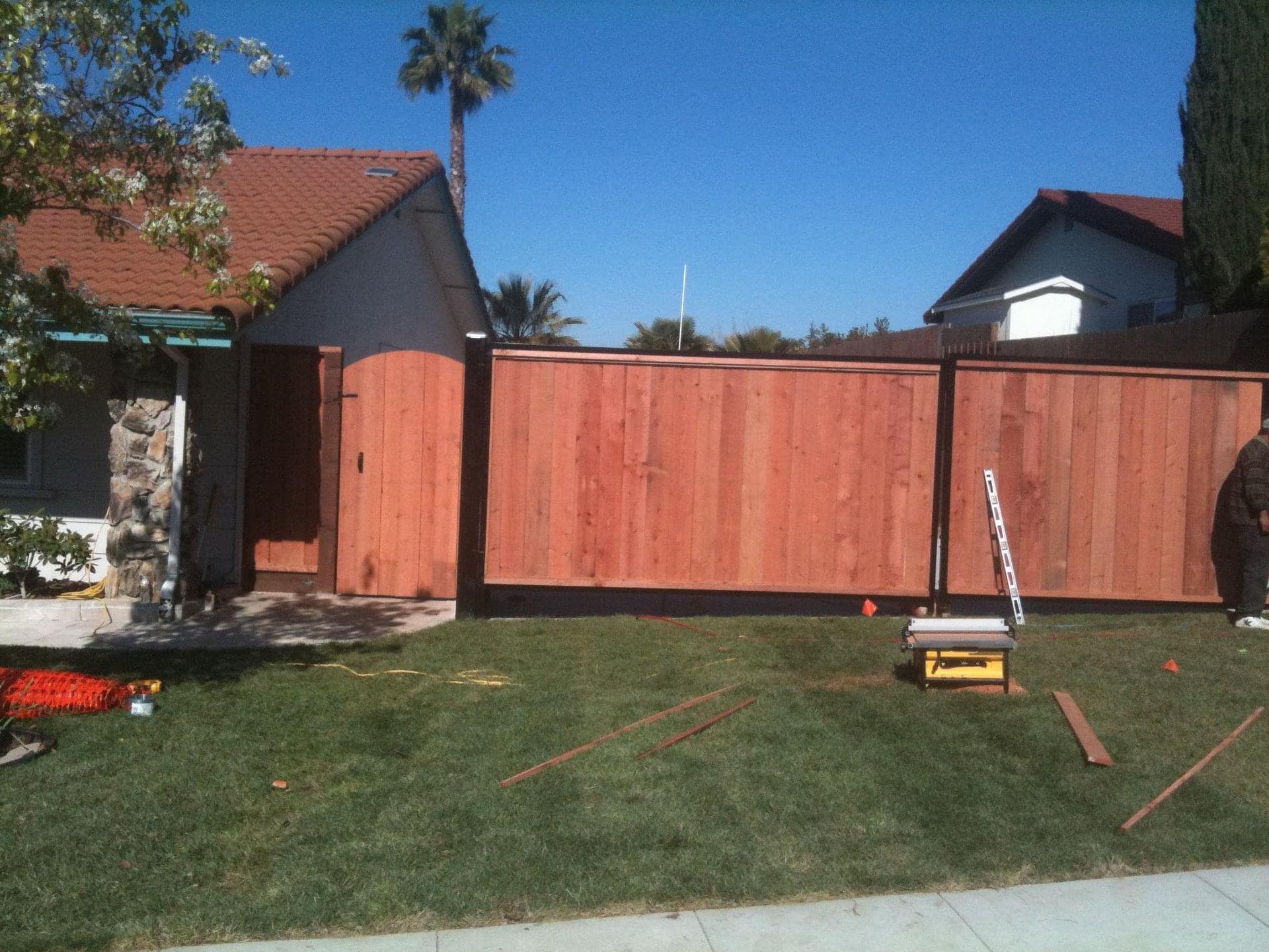 A wooden fence is being built in front of a house