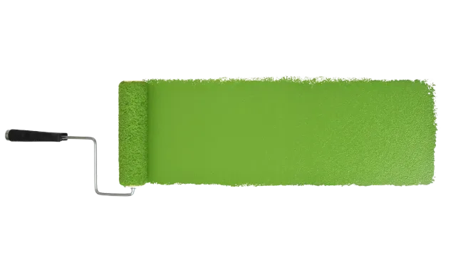 A paint roller with green paint on a white wall.