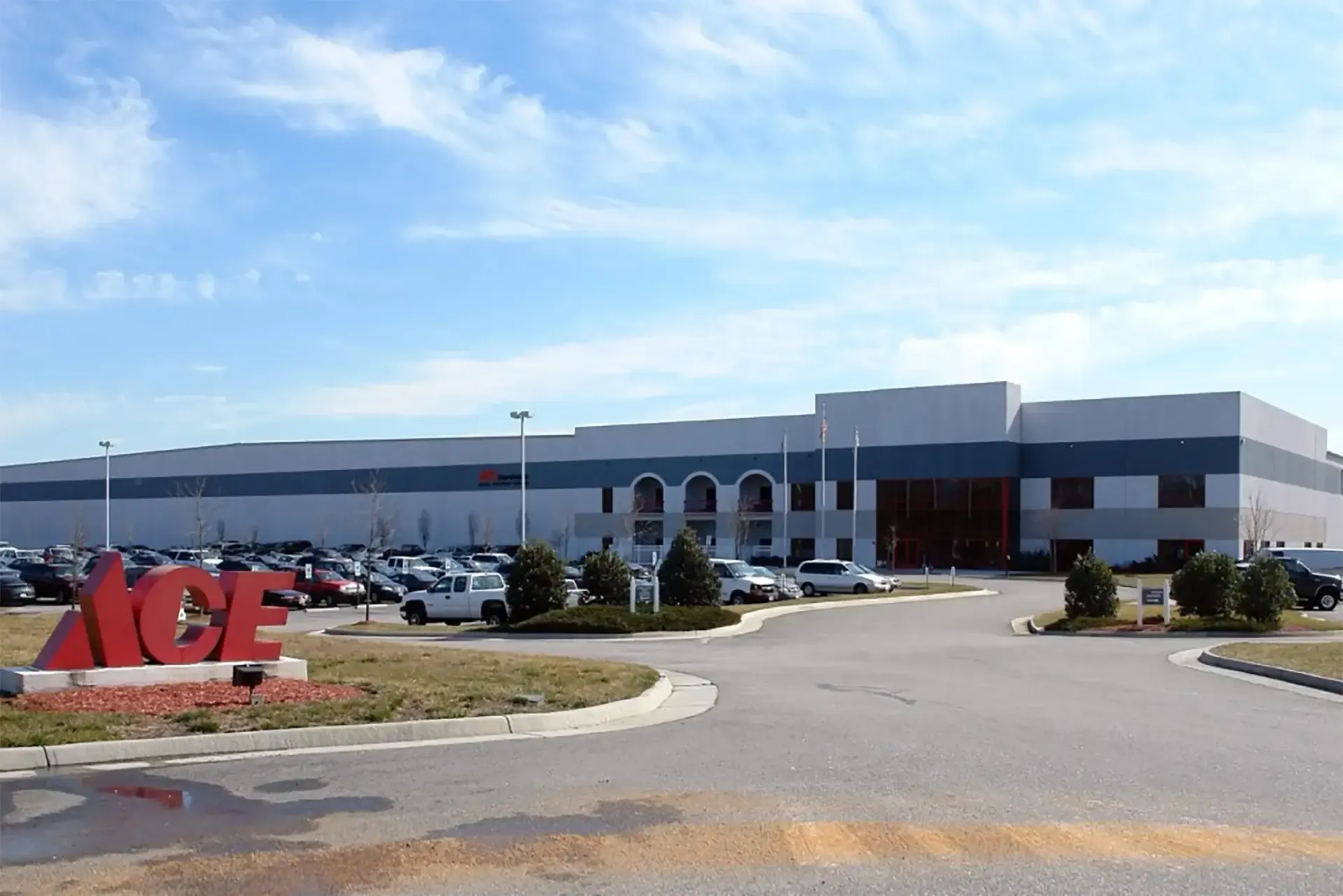 A large building with a lot of cars parked in front of it.