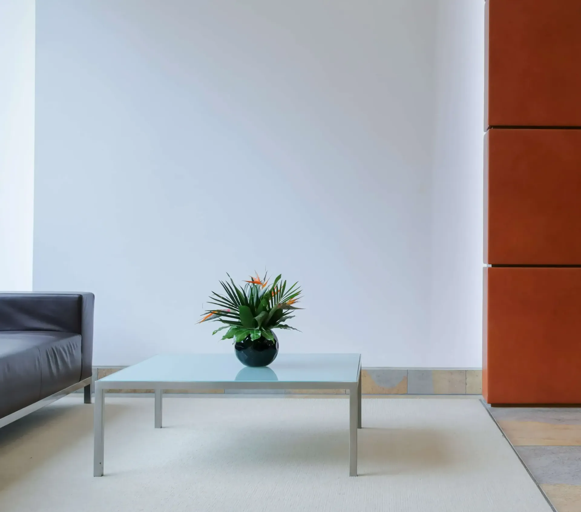 A coffee table with a potted plant on it in a living room