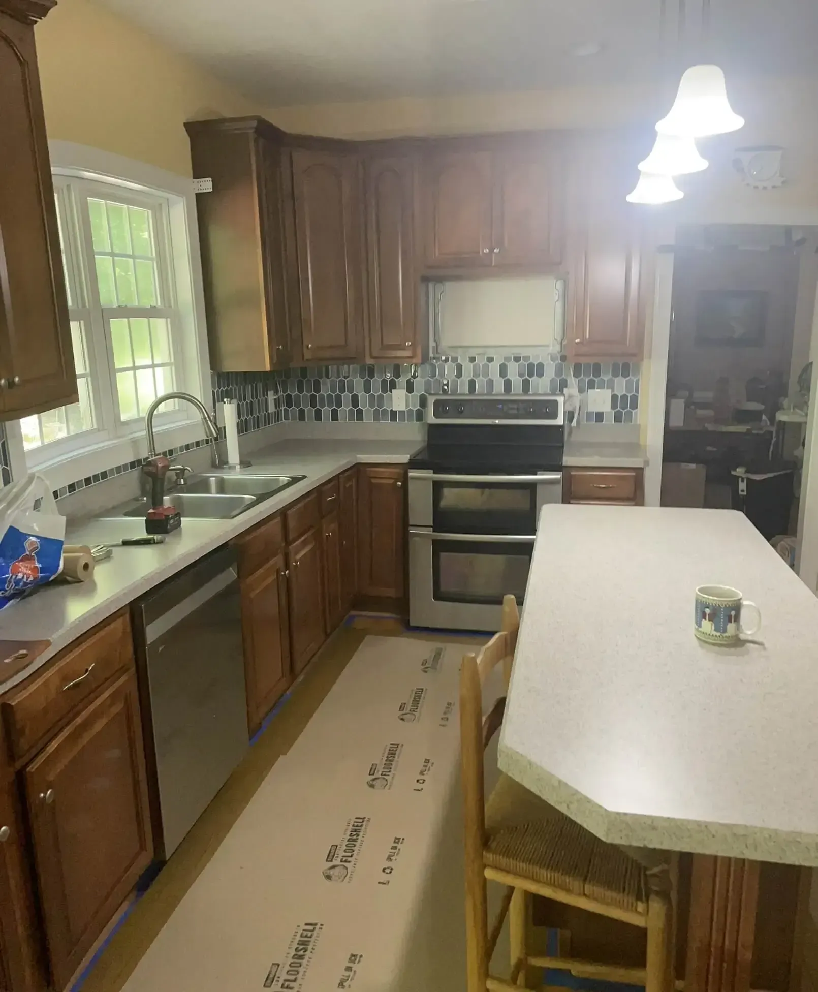 A kitchen with a stove top oven and a sink