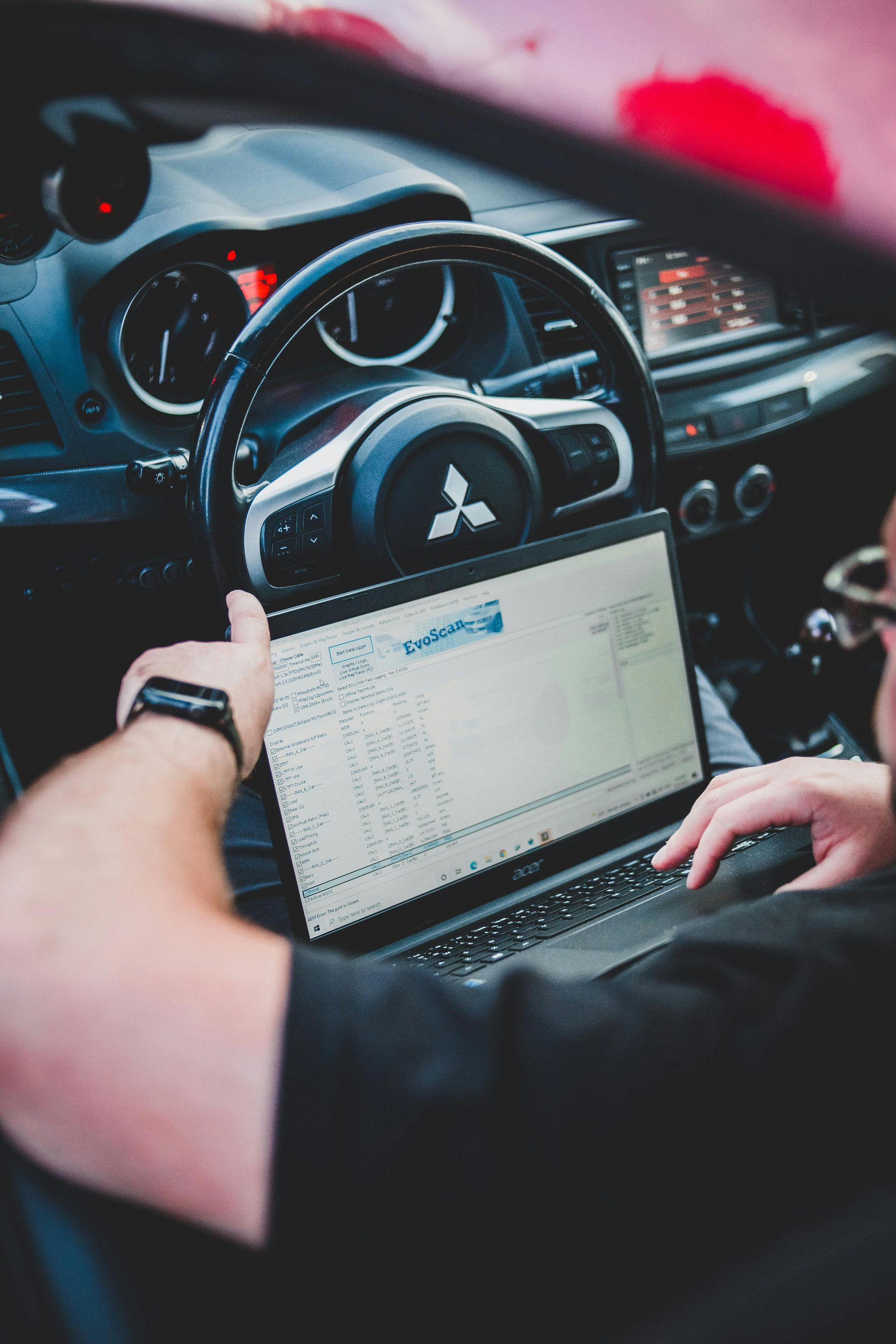 Technician Running Vehicle Diagnostics On Laptop Inside Car | Norgren's Auto Center