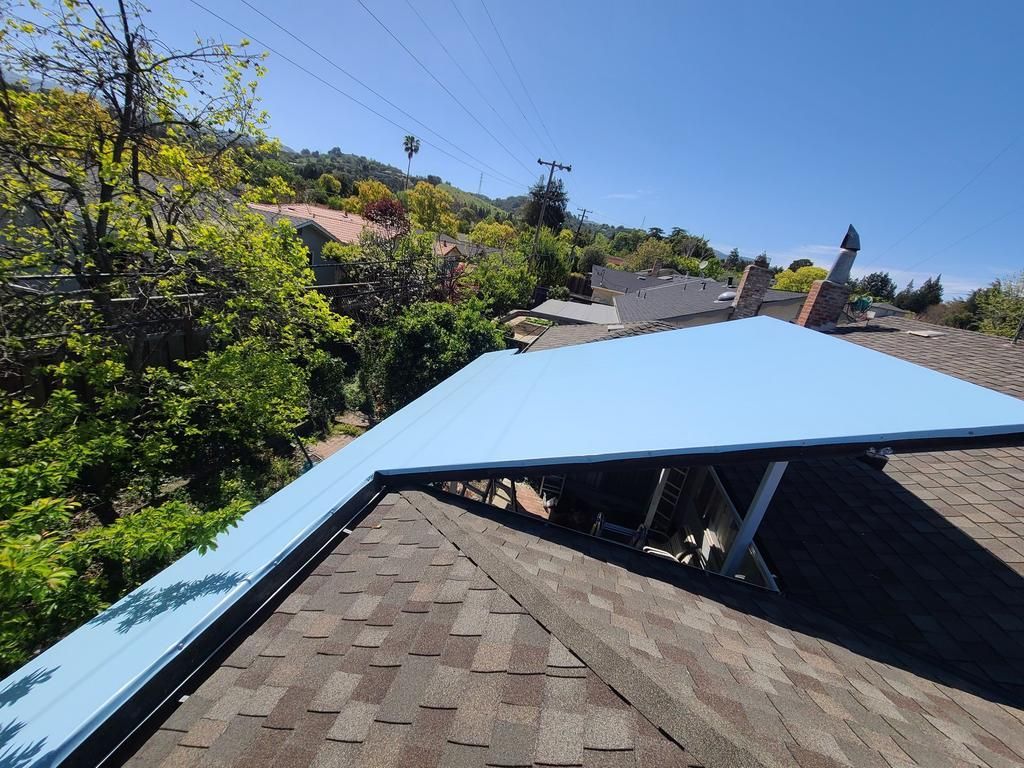 A roof with a blue roofing material on it