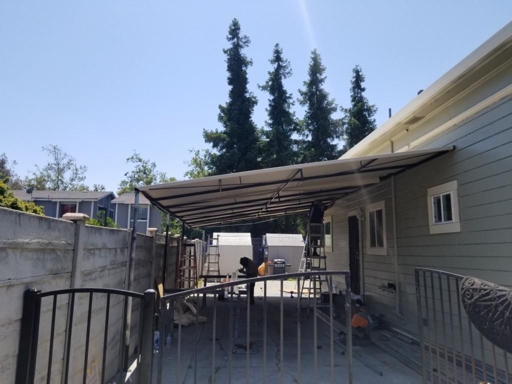 A house with a metal structure in front of it
