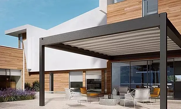 There is a pergola on the patio of a house.