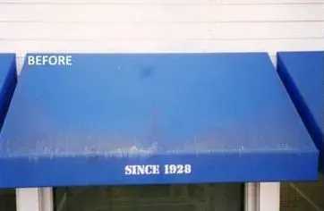 A blue awning is sitting on top of a window.