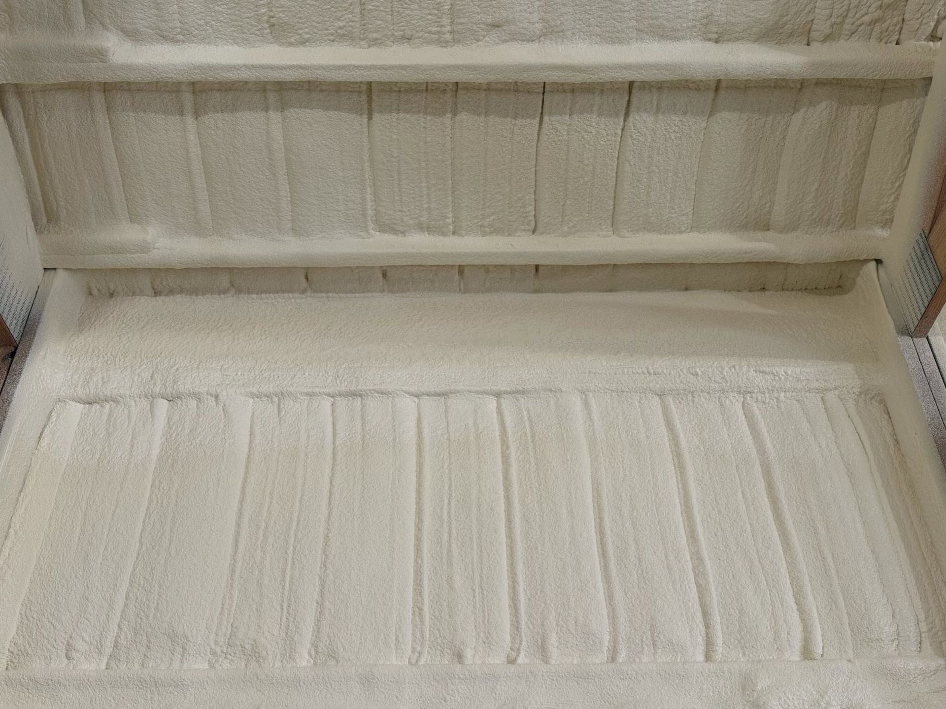 Open cardboard box lined with white foam inserts and dividers