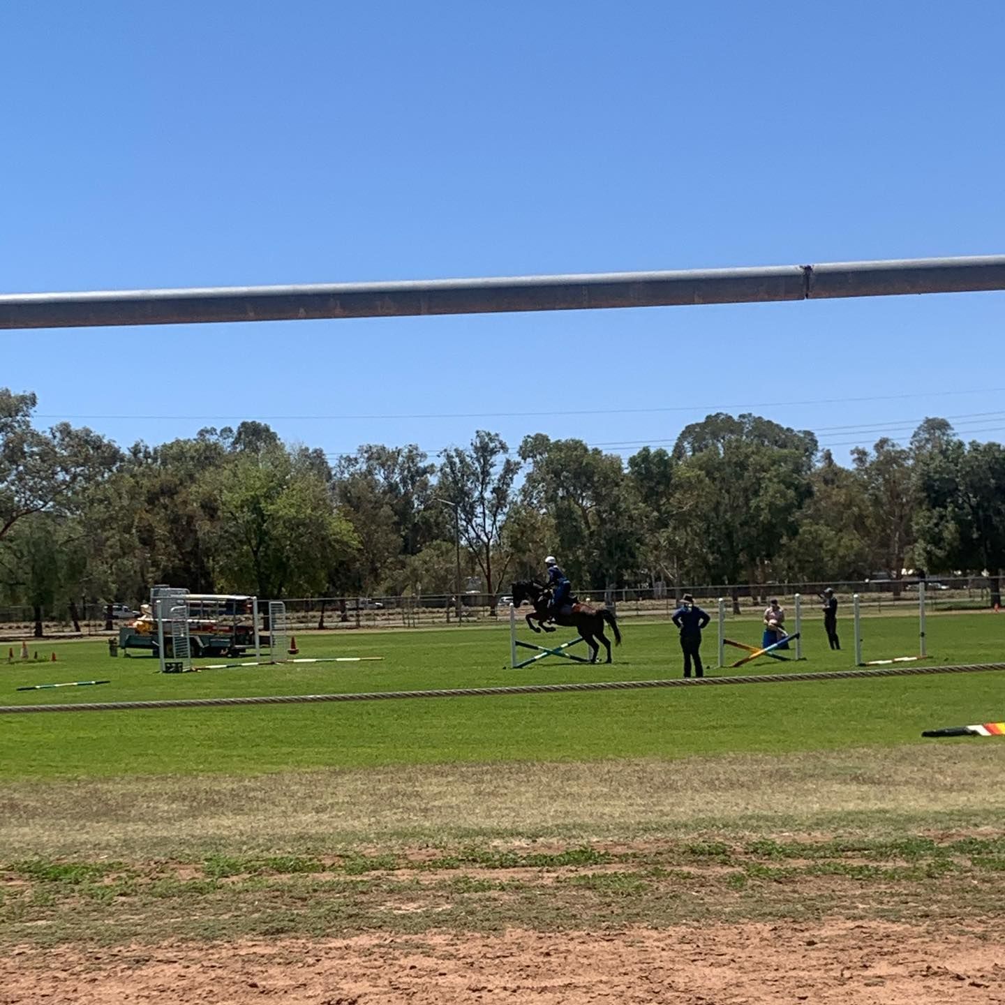 Horse Rider Jumping a Fence on A Grassy Field During a Sunny Outdoor Event — Blatherskite Park in Ilparpa, NT