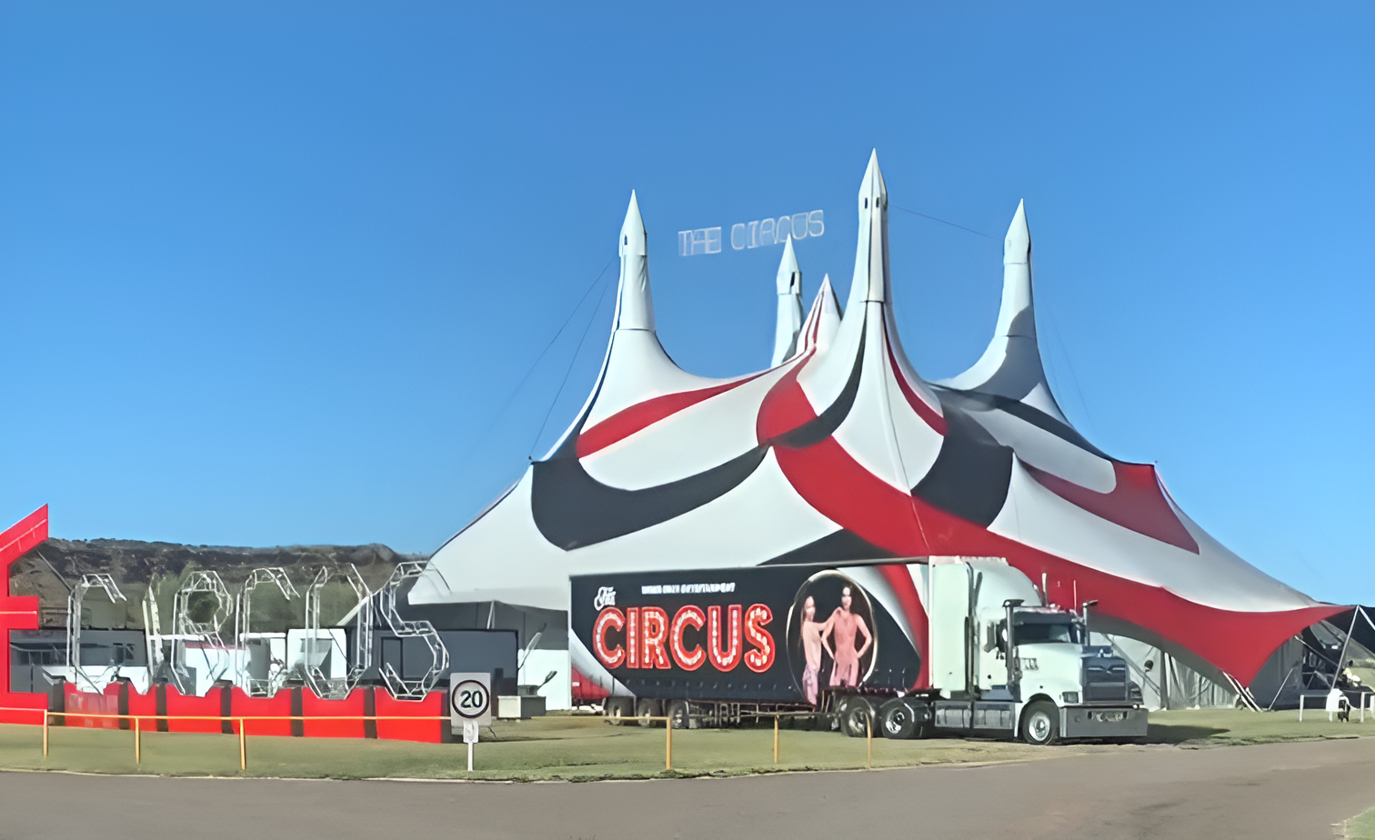 Circus Tent with Red and White Stripes Under a Blue Sky with A Circus Sign — Blatherskite Park in Ilparpa, NT