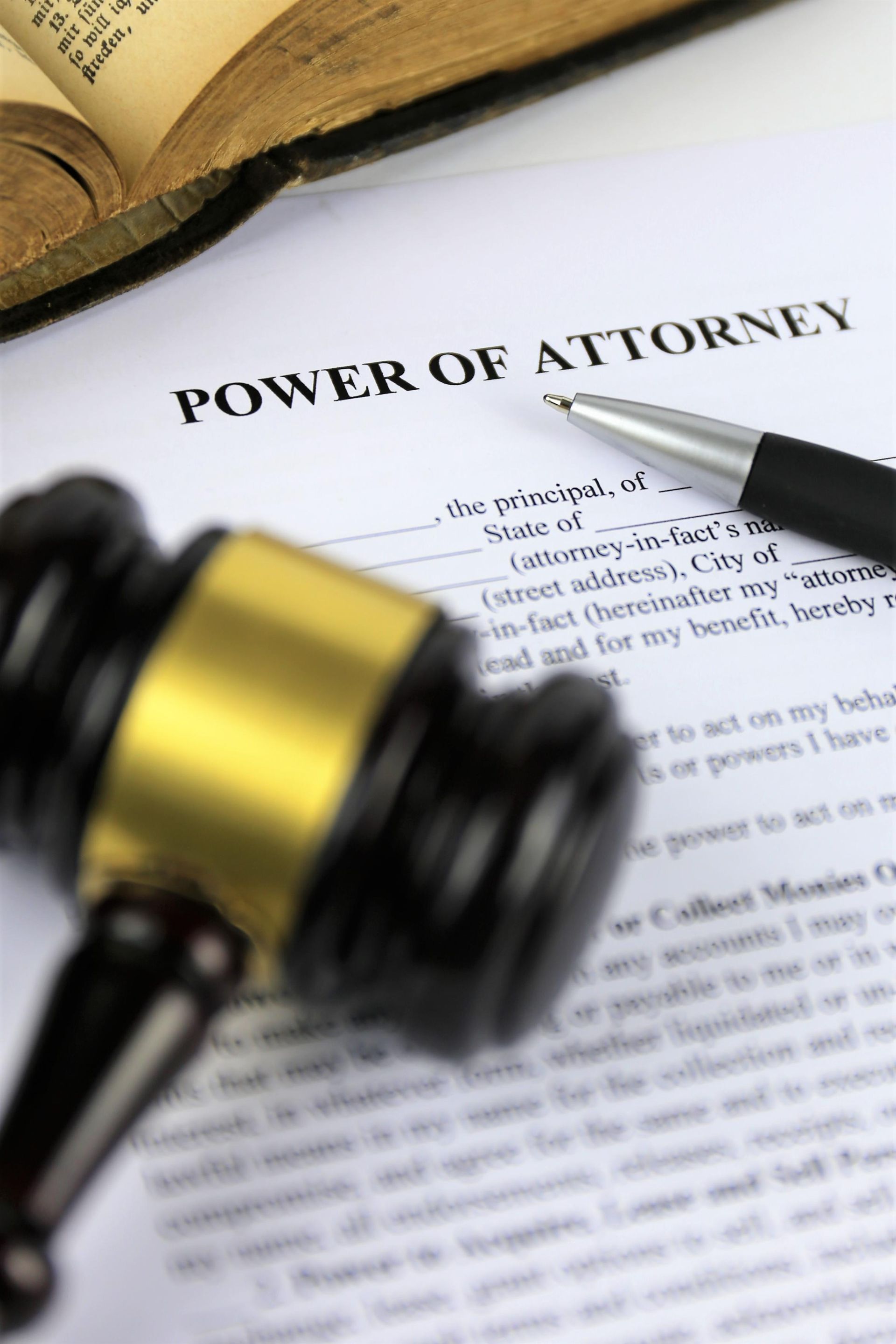 Power of attorney document with a gavel and pen on a desk