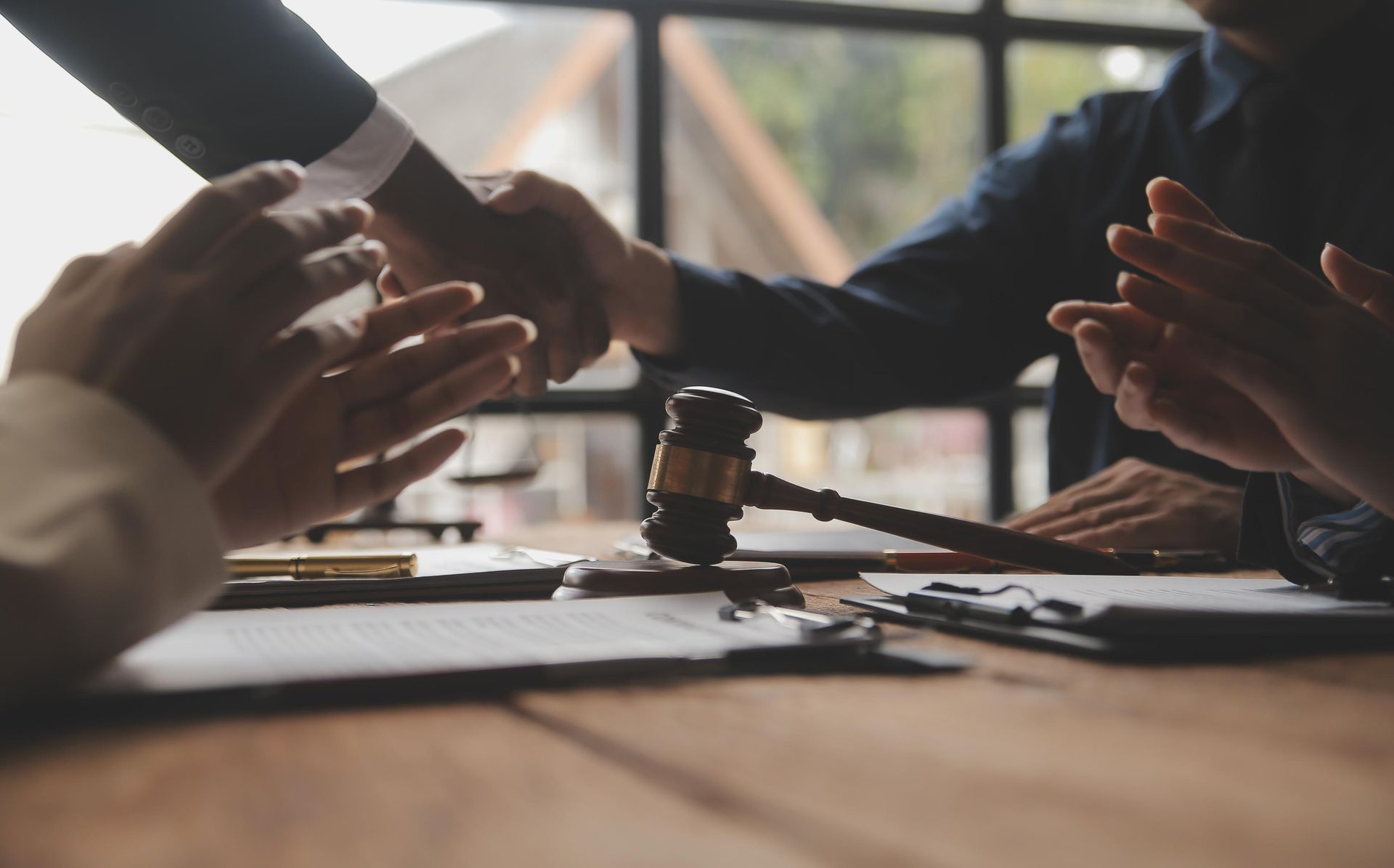 Lawyers discussing a case at a desk with a gavel and documents in a meeting room