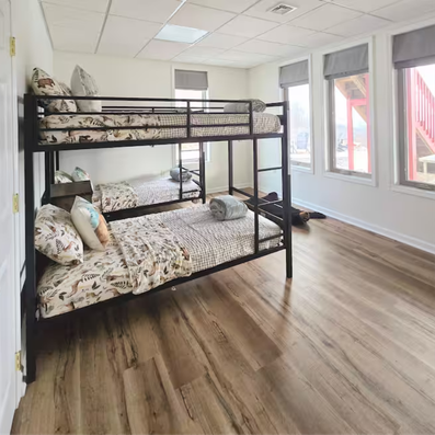 Bunk bed with metal frame and patterned bedding.