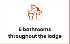 Icon of a toilet and sink above the text: 6 bathrooms throughout the lodge.