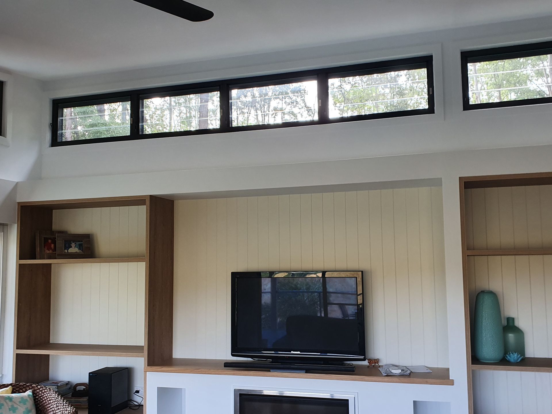 A living room with a fireplace and a flat screen tv