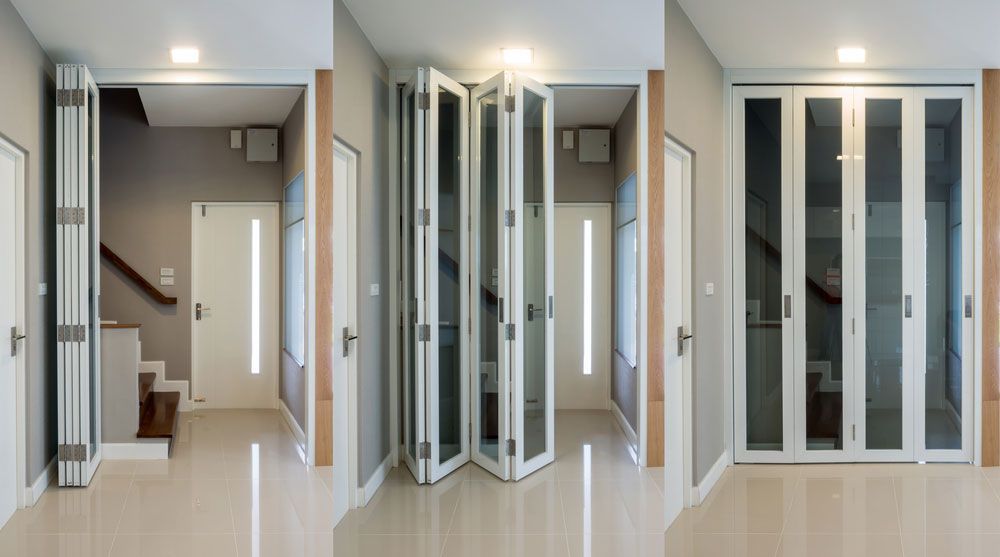 Interior design of wooden staircase with folding doors — Windows & Doors in Armidale, NSW