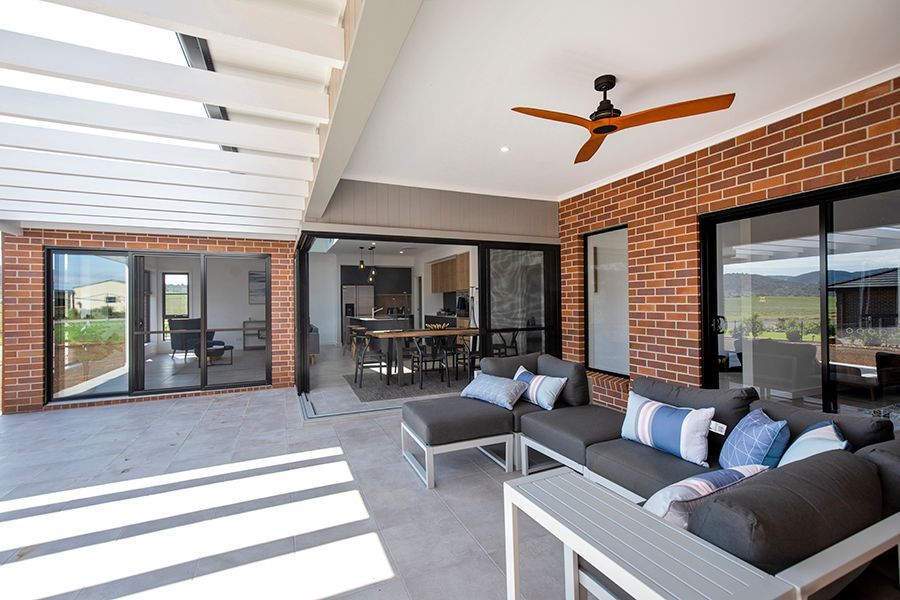 A patio with a couch and a ceiling fan