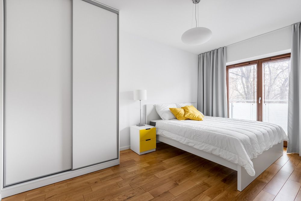 Modern bedroom with white wardrobe and double bed — Sliding Wardrobe Doors in Tamworth, NSW