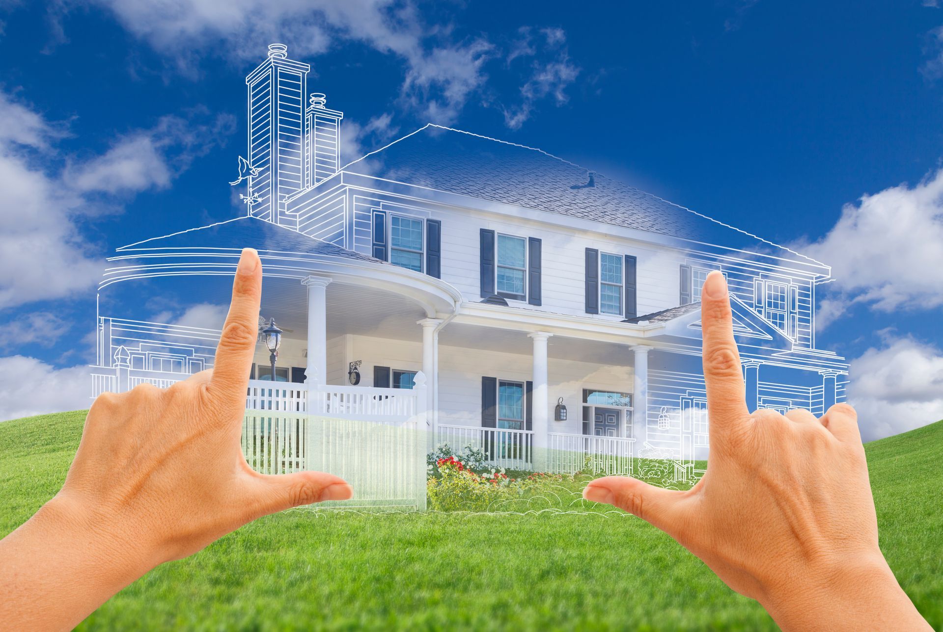 A person is holding up their hands in front of a drawing of a house.