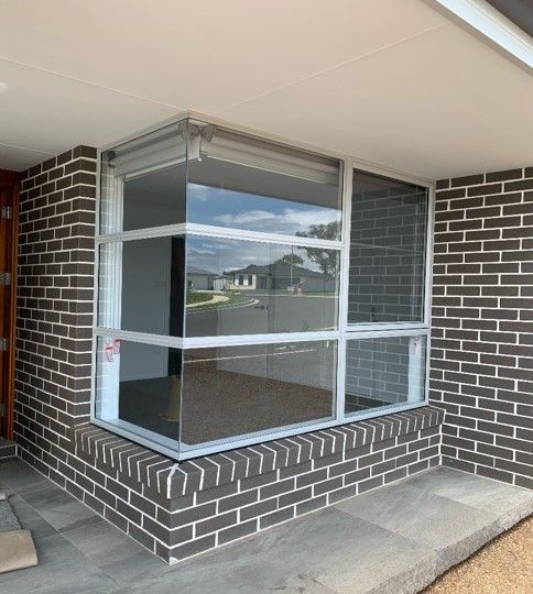 A large window on the side of a brick building