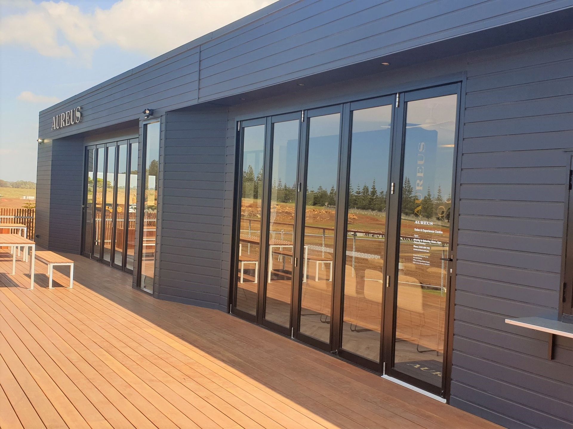 A large building with a lot of windows and a wooden deck.