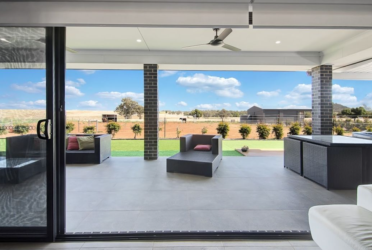 A living room with a sliding glass door leading to a patio.