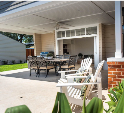 A patio with a table and chairs on it