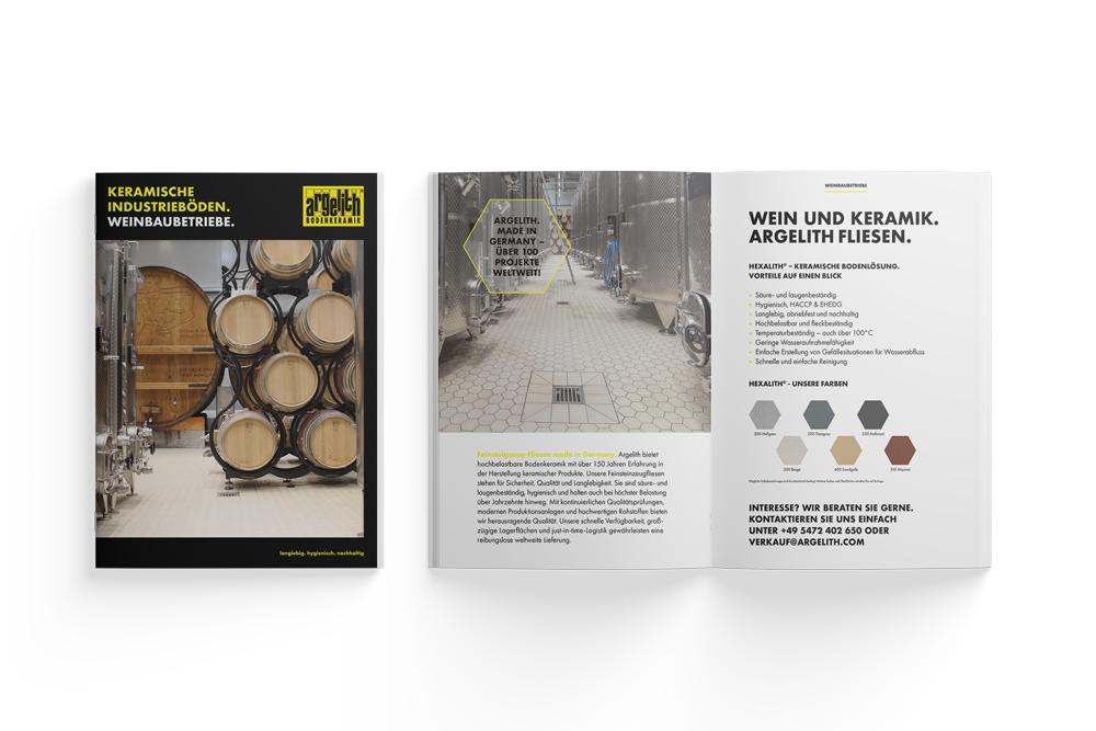 A brochure with a picture of barrels in a wine cellar.