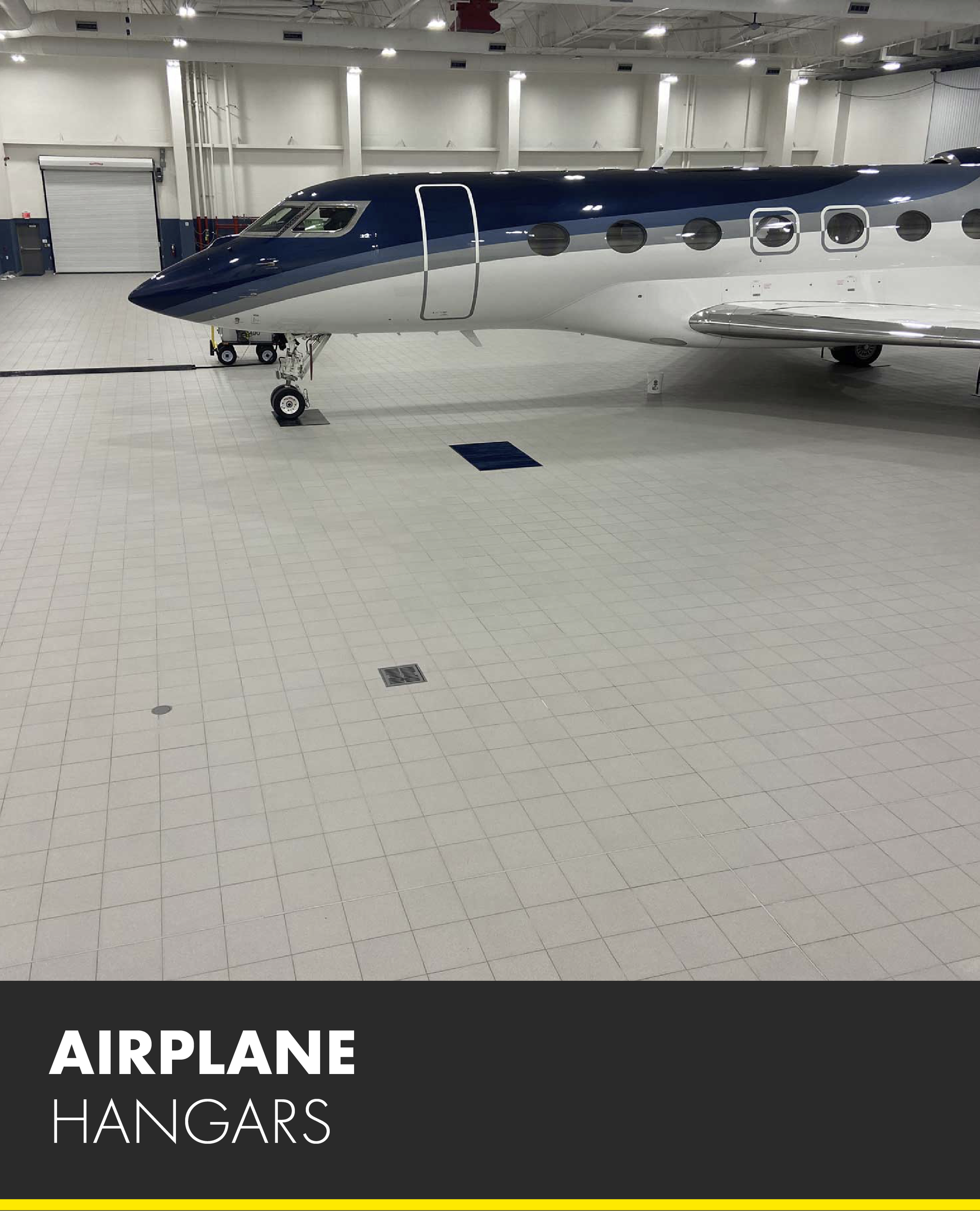 A blue and white airplane is parked in an airplane hangar