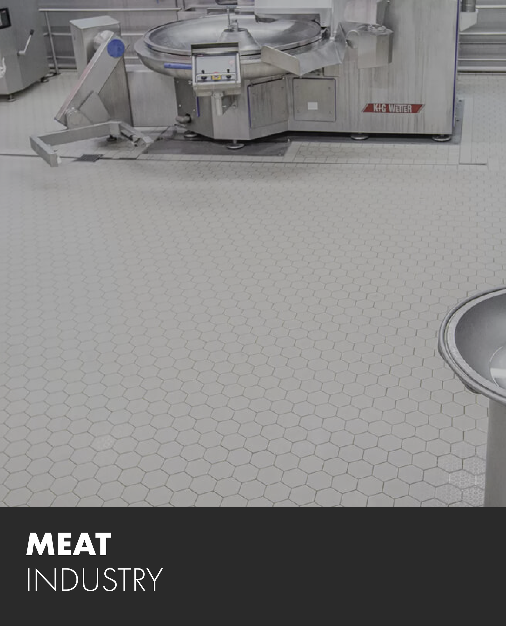 A picture of a meat industry machine on a tiled floor