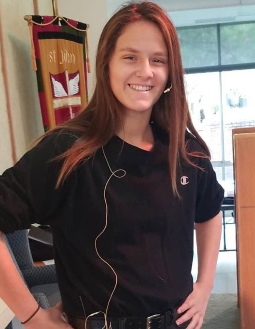 A girl wearing a black shirt with the word champion on it