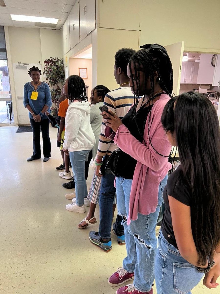 A group of people are standing in a line in a room.
