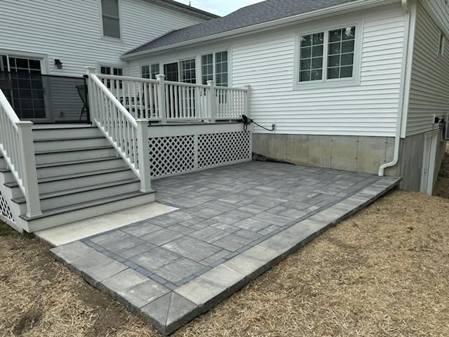 A White House With A Patio And Stairs In Front Of It | Husdon Valley, NY | Bastian Lawn and Landscape, LLC