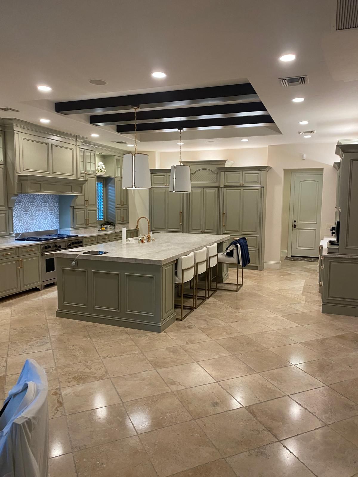 A large kitchen with a large island in the middle of it.