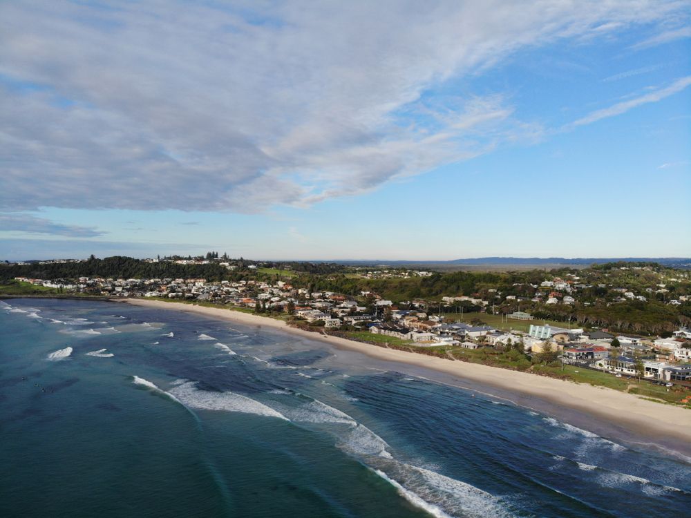 Aerial View of Beach With Houses Along the Coast Under a Blue Sky — Intolec Electrical In Ballina, NSW
