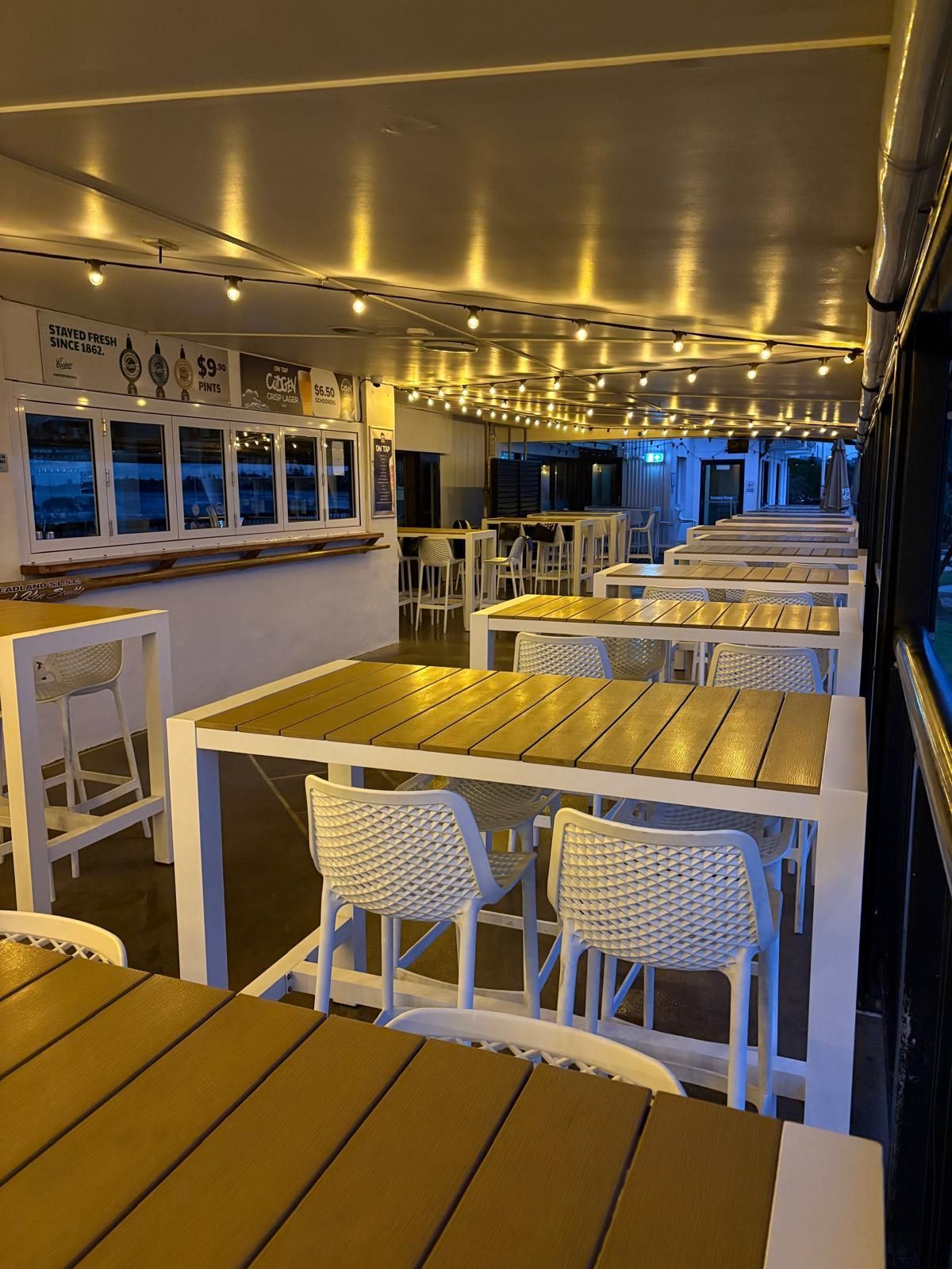 Outdoor Bar With Tables, Chairs, and String Lights Overhead — Intolec Electrical in Tweed Heads, NSW