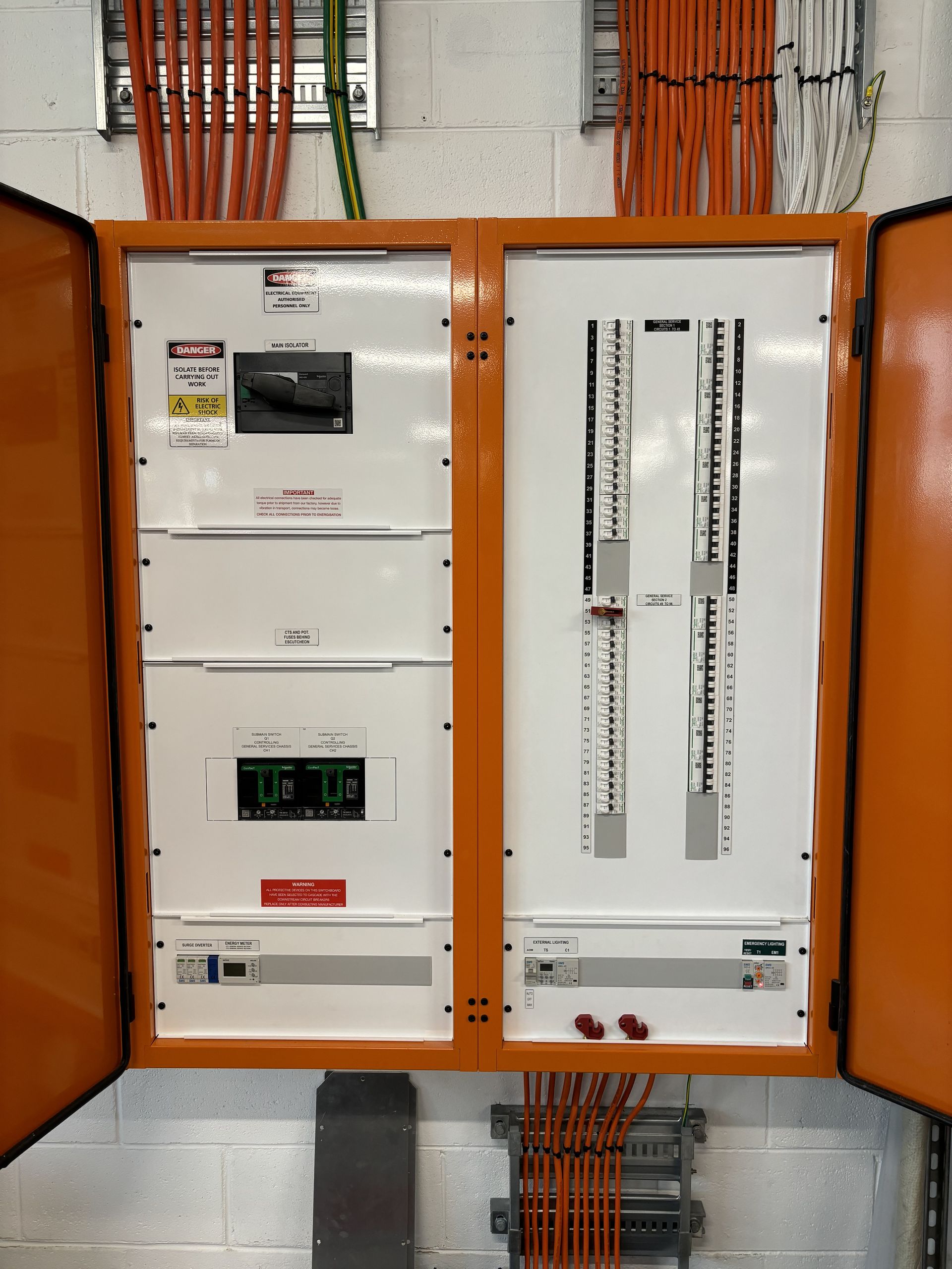 Orange Electrical Panel With Open Doors, Displaying Various Components and Wiring — Intolec Electrical in Tweed Heads, NSW