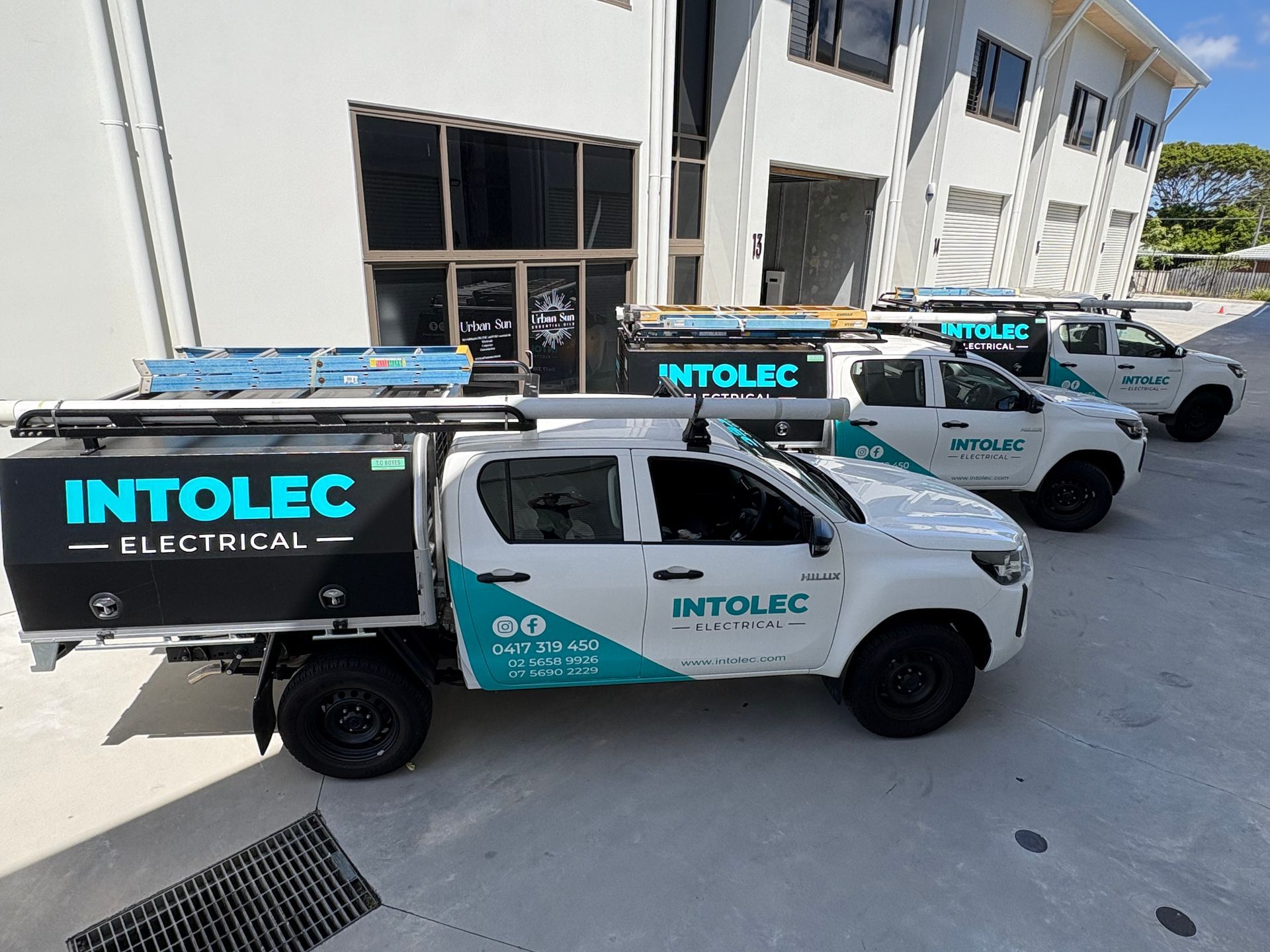 Three White INTOLEC Electrical Trucks — Intolec Electrical in Tweed Heads, NSW