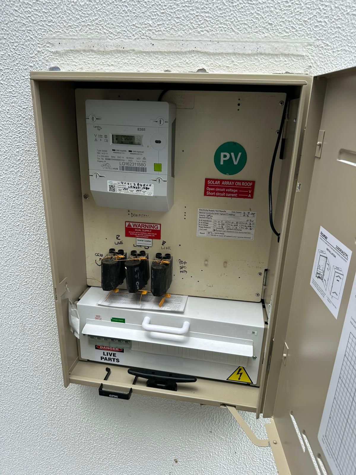 Electrical box containing a meter, fuses, and disconnect switch labeled