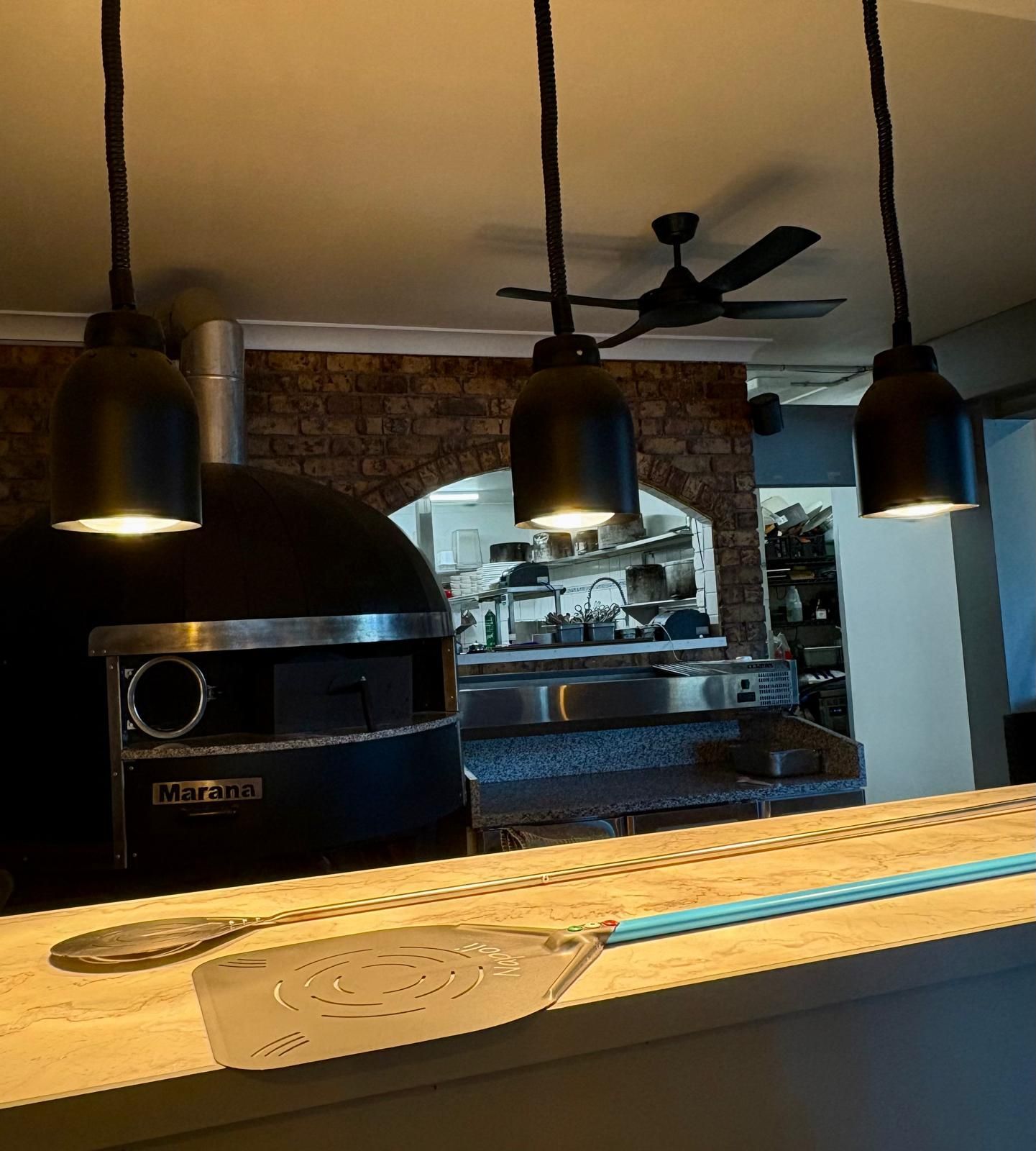 Pizza Oven and Kitchen Viewed From Counter With Three Pendant Lights — Intolec Electrical in Tweed Heads, NSW