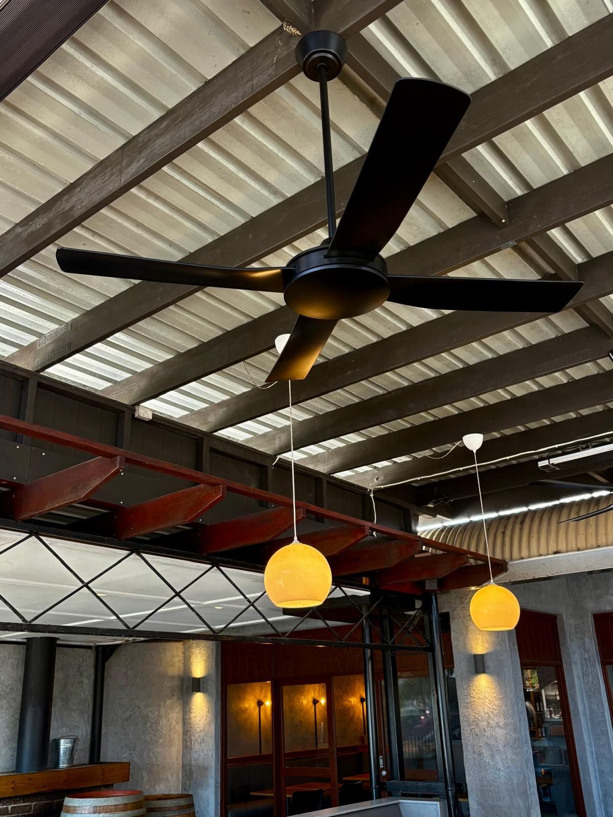 Black Ceiling Fan Suspended From a Metal Roof — Intolec Electrical in Tweed Heads, NSW
