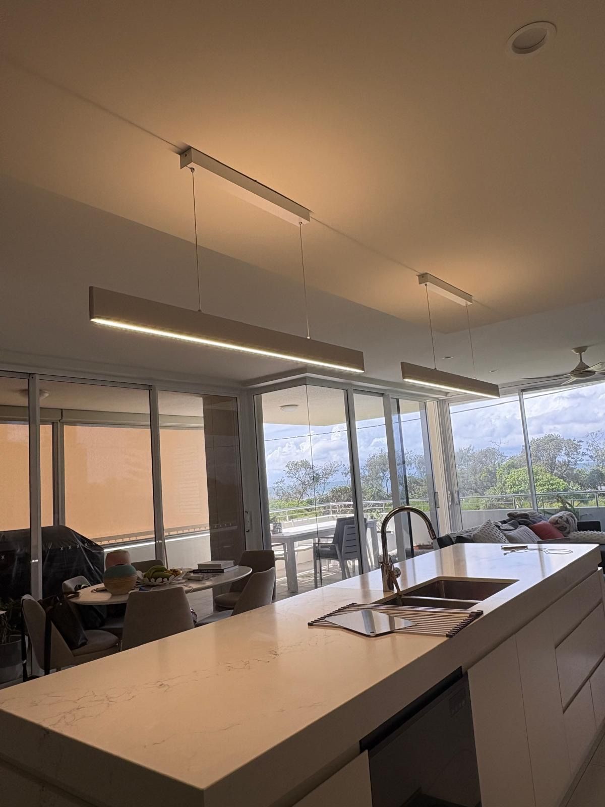 Modern Kitchen With White Countertops and Hanging Rectangular Lights — Intolec Electrical in Tweed Heads, NSW